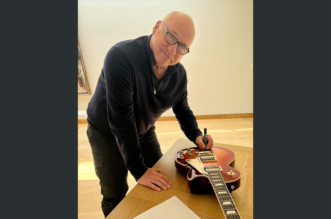 Mark Knopfler Has Officially Signed the Gibson Guitar for The Streets of London Fundraising