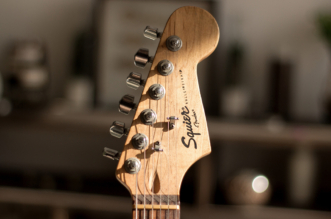 Beginner guitarist practicing guitar and learning how to avoid common guitar mistakes