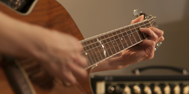 Beginner guitarist practicing essential guitar techniques on an electric guitar