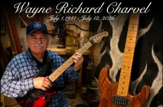Wayne Charvel with a vintage Charvel electric guitar